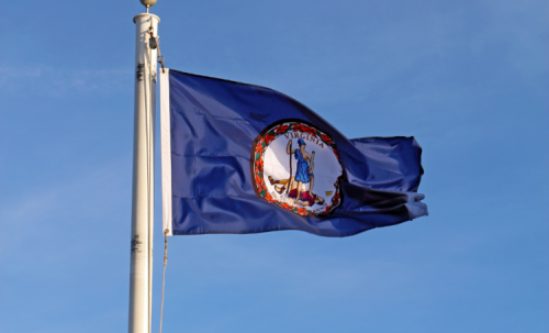 Virginia Flag waves before a bright blue sky